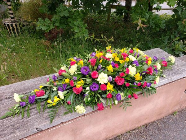 bright flower spray-double ended casket spray-funeral flowers-florist-torbay
